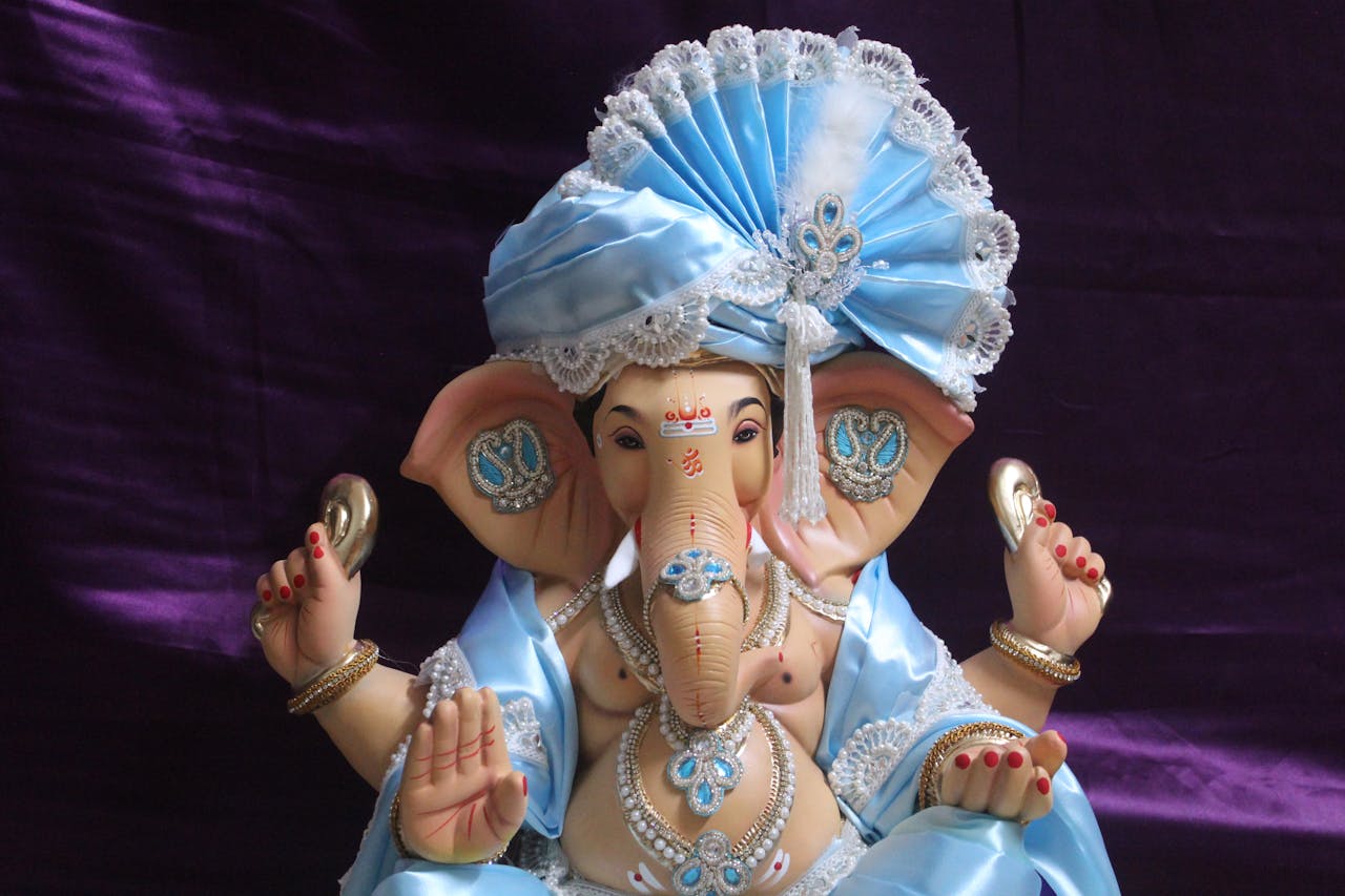 hero-homepage Beautifully crafted Lord Ganesha idol adorned with blue attire, perfect for Ganesh Chaturthi celebrations.